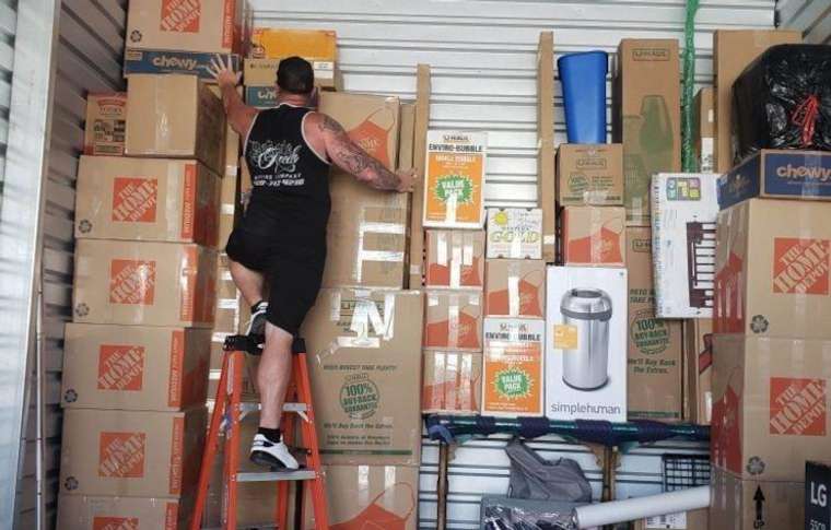 Movers loading boxes and furniture into a moving truck
